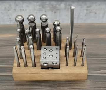 Jewelry crafting tools including gold, iron, and silver manual punch heads, anvil, steel mold, and large four-sided and six-sided pits are available, accompanied by a one-year warranty.