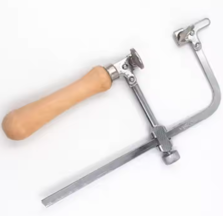 Jeweler's saw frame kit comprising 12 adjustable blades, designed for precision cutting of metal and wax rings, serves as an essential tool for jewelry making.